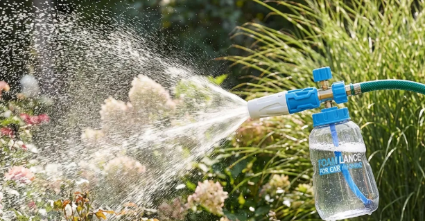 An image of a nozzle in a garden spraying a high-pressure stream of water.